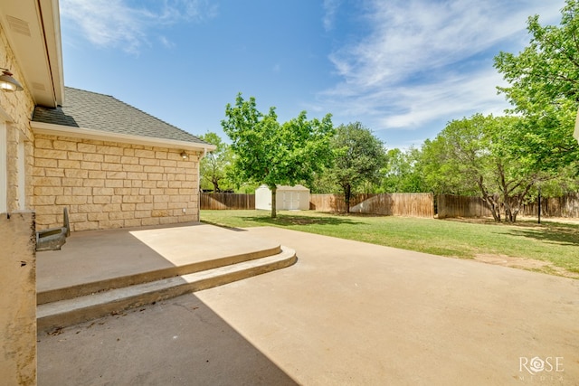 view of patio / terrace featuring a storage unit, an outbuilding, and a fenced backyard
