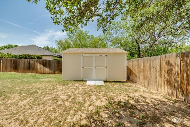view of shed with a fenced backyard