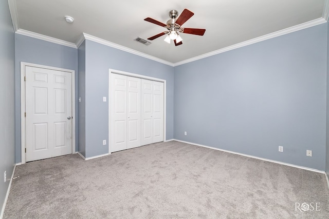 unfurnished bedroom featuring baseboards, visible vents, ornamental molding, and carpet flooring