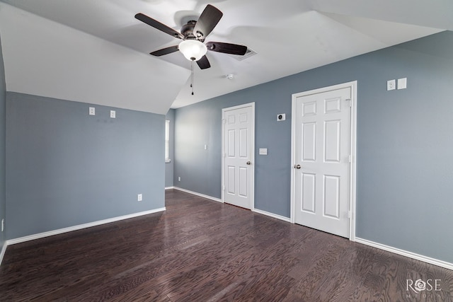 unfurnished room with ceiling fan, vaulted ceiling, wood finished floors, and baseboards
