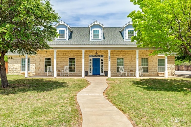 cape cod-style house featuring a front lawn and covered porch