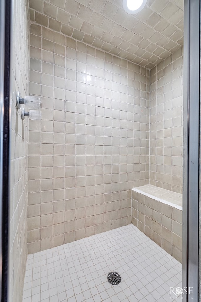 full bath with a tile shower
