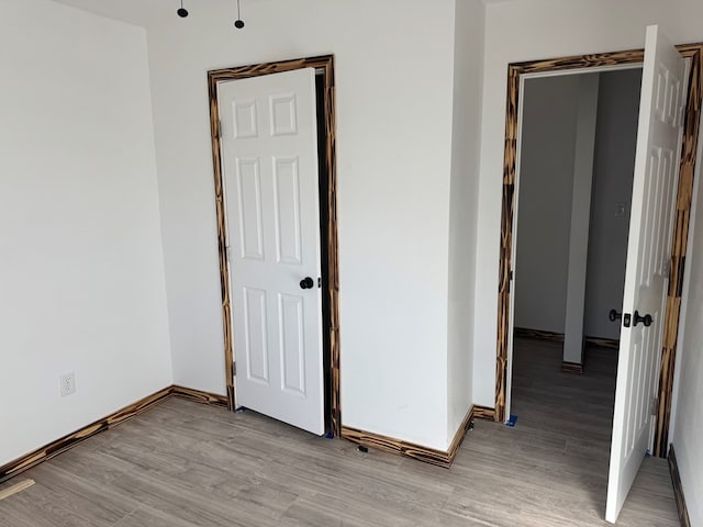 unfurnished room with light wood-type flooring