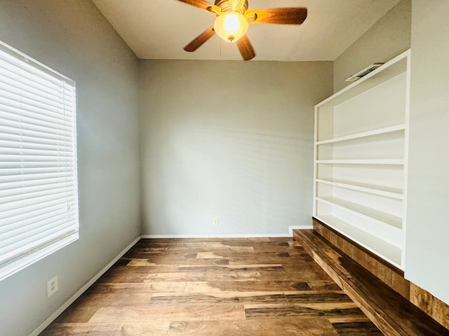 spare room featuring wood-type flooring and ceiling fan