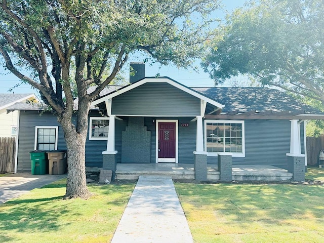 view of front of home featuring a front yard and covered porch