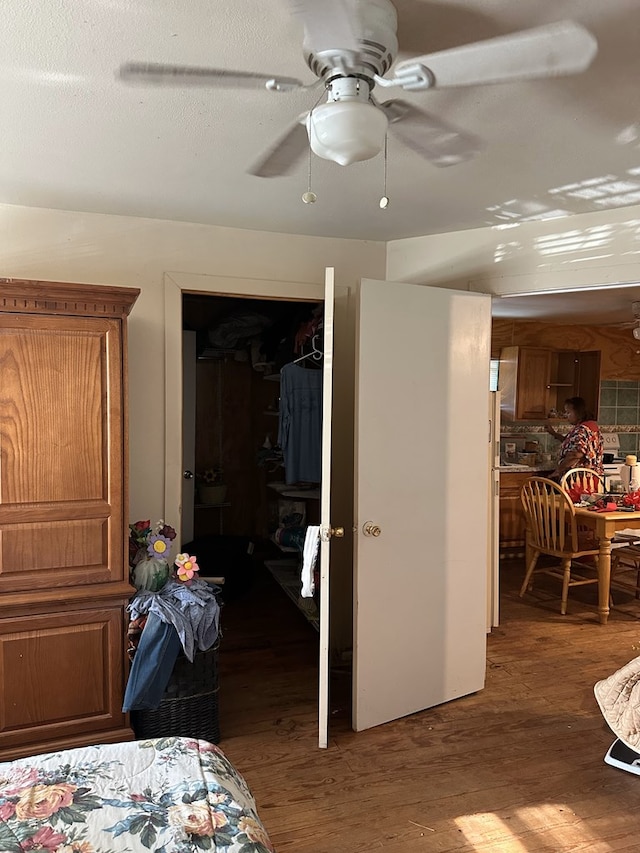 bedroom featuring dark wood-type flooring, ceiling fan, and a closet