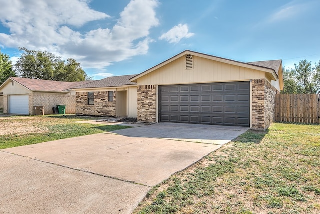 ranch-style home with a garage and a front yard