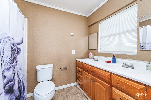 bathroom with vanity, crown molding, tile patterned floors, and toilet