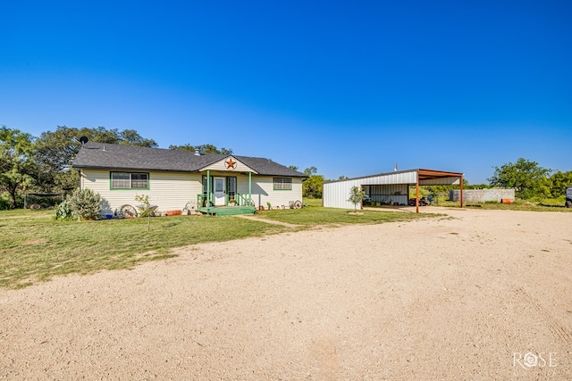 ranch-style house with a front yard and a carport