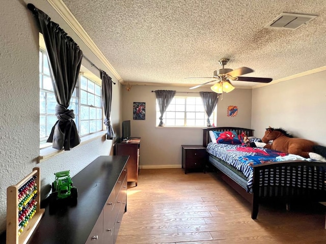 bedroom featuring crown molding, a textured ceiling, and ceiling fan