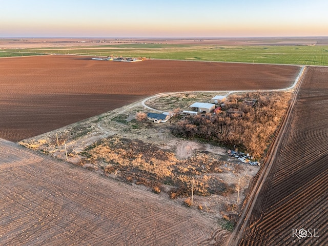 aerial view at dusk featuring a rural view