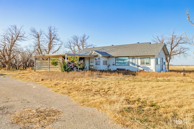 ranch-style home with a carport