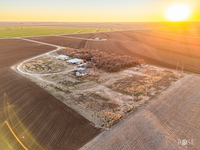 aerial view at dusk featuring a rural view