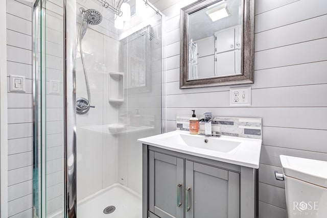 bathroom with vanity, toilet, and a shower with shower door