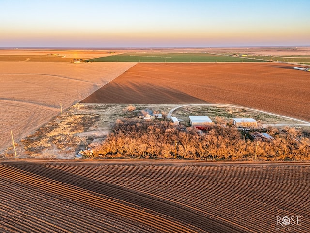 aerial view at dusk featuring a rural view