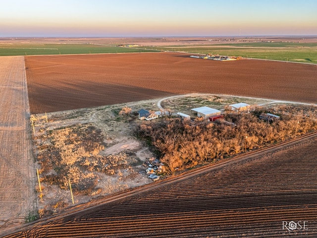 aerial view at dusk featuring a rural view