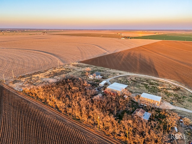 aerial view at dusk featuring a rural view