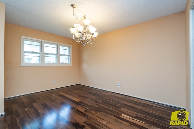 2720 Tanglewood Dr, San Angelo, TX 76904 - empty room with a chandelier and dark wood-type flooring