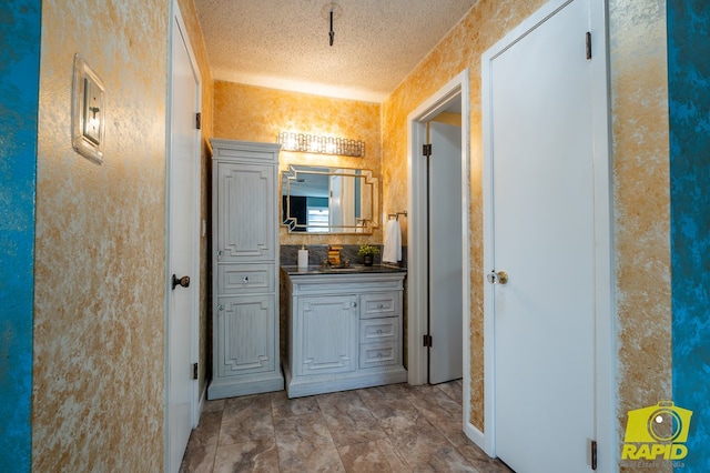 2720 Tanglewood Dr, San Angelo, TX 76904 - bathroom with vanity and a textured ceiling