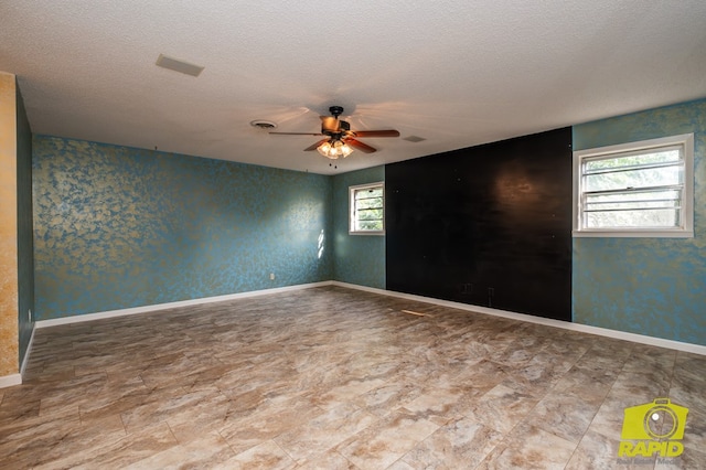 2720 Tanglewood Dr, San Angelo, TX 76904 - empty room with ceiling fan, a textured ceiling, and baseboards