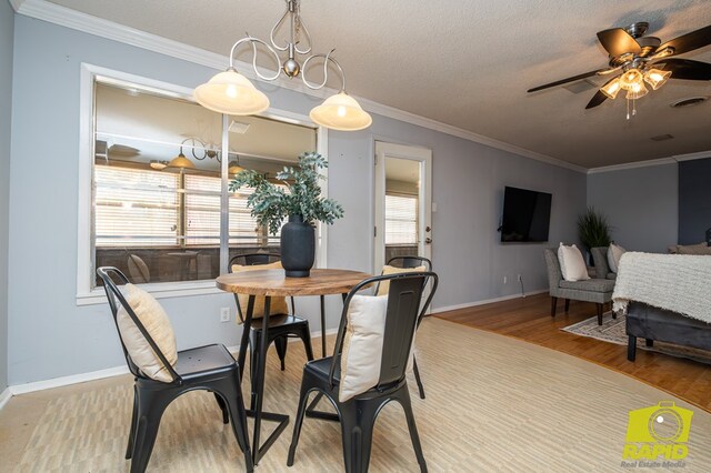 2720 Tanglewood Dr, San Angelo, TX 76904 - dining area featuring wood finished floors, crown molding, a ceiling fan, baseboards, and a textured ceiling