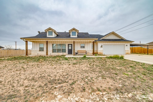 view of front of home featuring covered porch and a garage