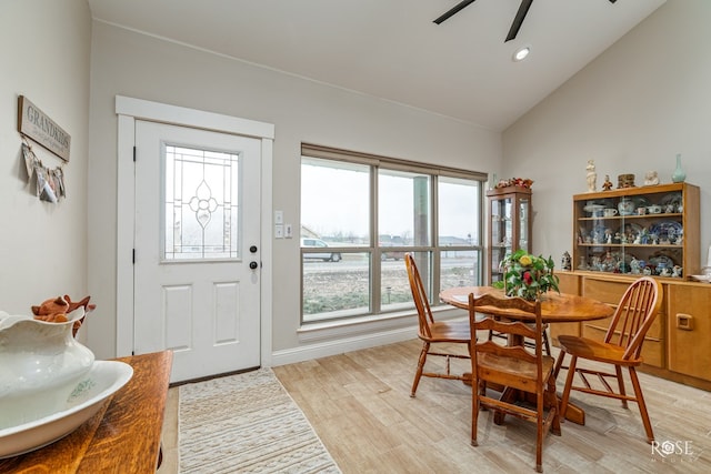 dining area with ceiling fan, light wood-type flooring, and lofted ceiling