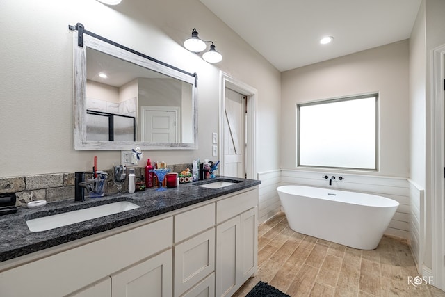 bathroom featuring vanity, hardwood / wood-style floors, and shower with separate bathtub