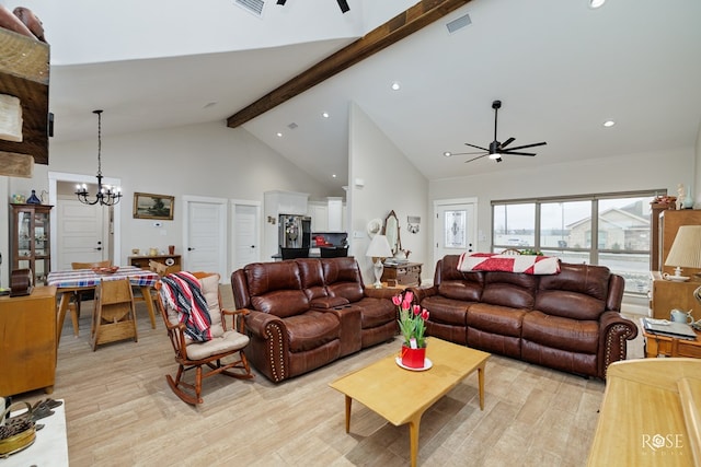 living room featuring high vaulted ceiling, beamed ceiling, light hardwood / wood-style floors, and ceiling fan with notable chandelier