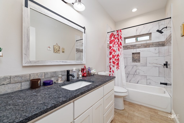 full bathroom with hardwood / wood-style flooring, vanity, toilet, and shower / bath combo