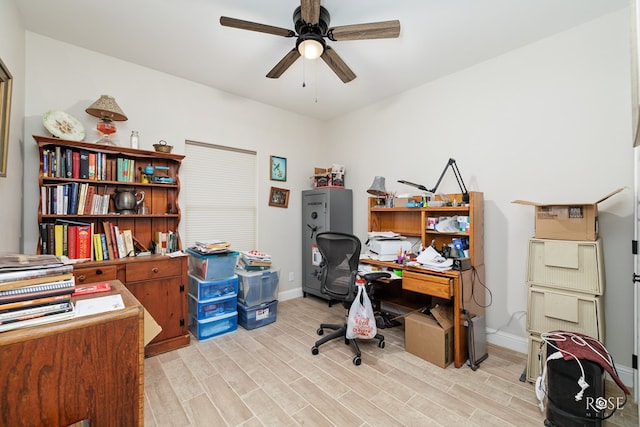 office with ceiling fan and light hardwood / wood-style floors