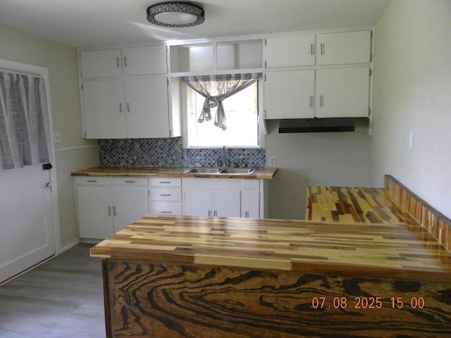 1611 N Magdalen St, San Angelo, TX 76901 - kitchen featuring wooden counters, wood finished floors, white cabinets, and backsplash