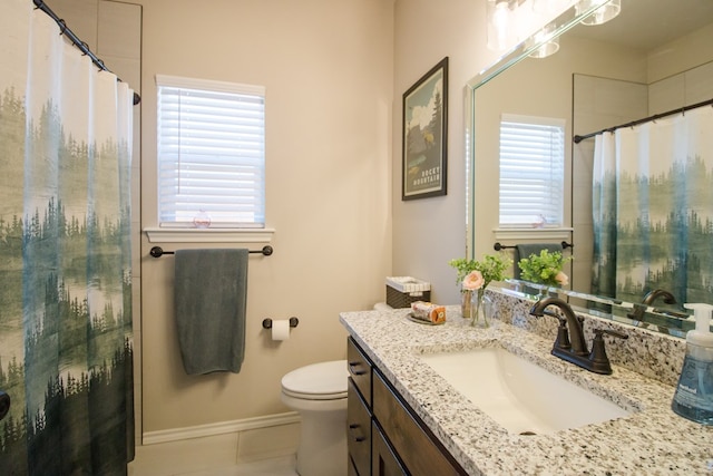 bathroom featuring tile patterned floors, vanity, and toilet