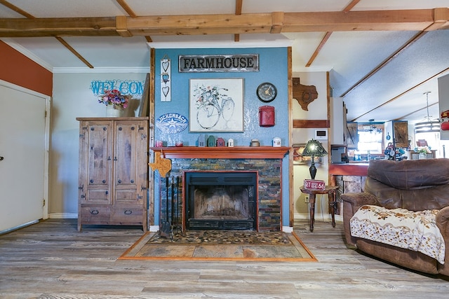 living room featuring a tile fireplace, baseboards, beamed ceiling, and wood finished floors