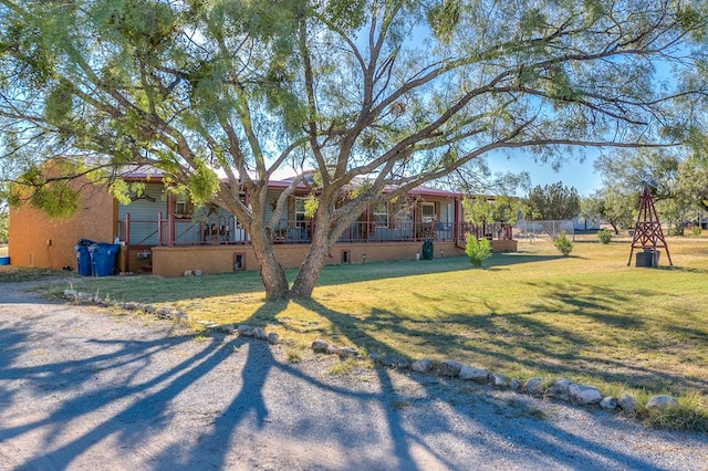 view of front of house featuring a front yard and a wooden deck