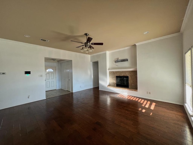 unfurnished living room with hardwood / wood-style flooring, ornamental molding, and ceiling fan