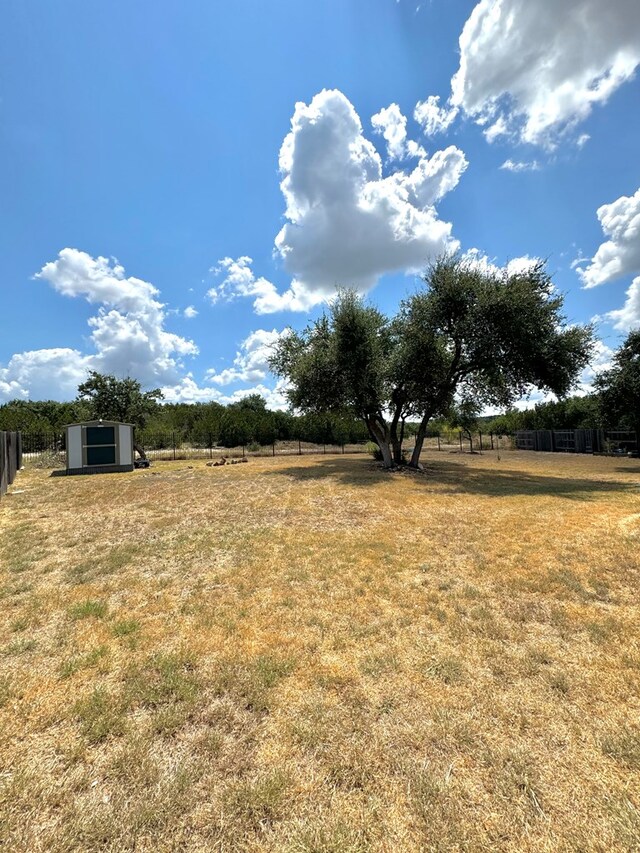 view of yard with a rural view and an outbuilding