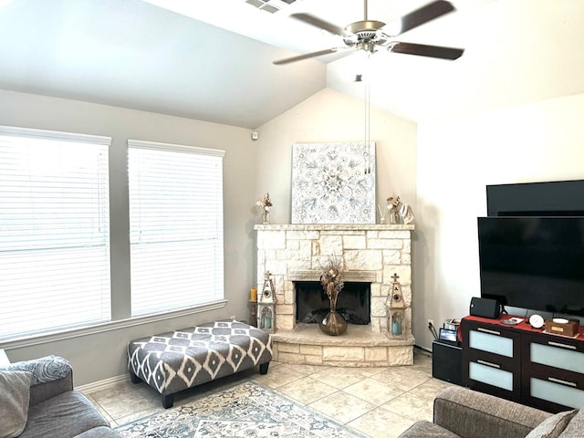 living room featuring lofted ceiling, light tile patterned floors, a fireplace, and ceiling fan