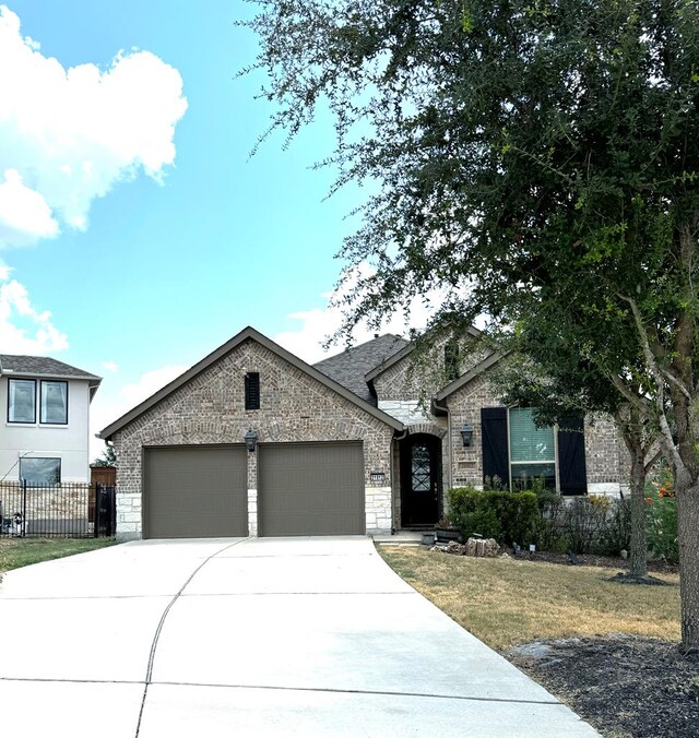 view of front facade with a garage and a front lawn