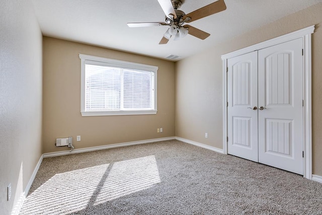 unfurnished bedroom featuring ceiling fan, light colored carpet, and a closet