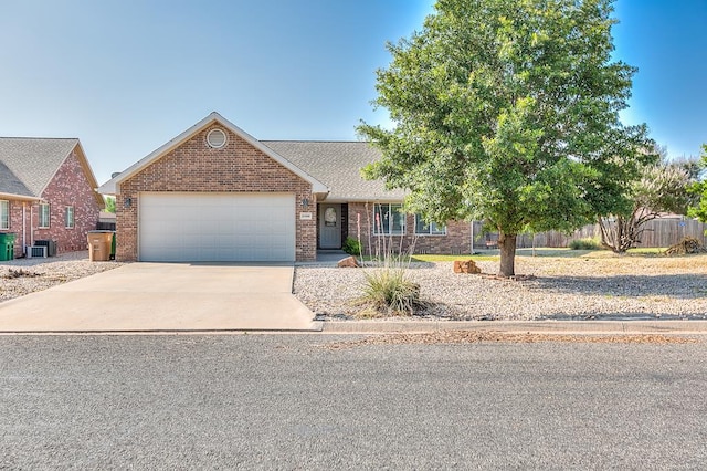 view of front of property with a garage and central AC