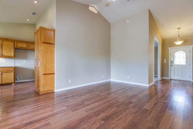 unfurnished living room with wood-type flooring, ceiling fan, and high vaulted ceiling