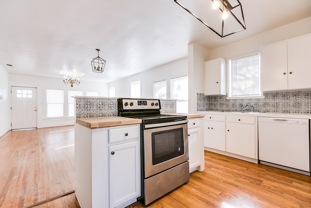 kitchen featuring white cabinetry, stainless steel electric range oven, light wood-type flooring, white dishwasher, and pendant lighting