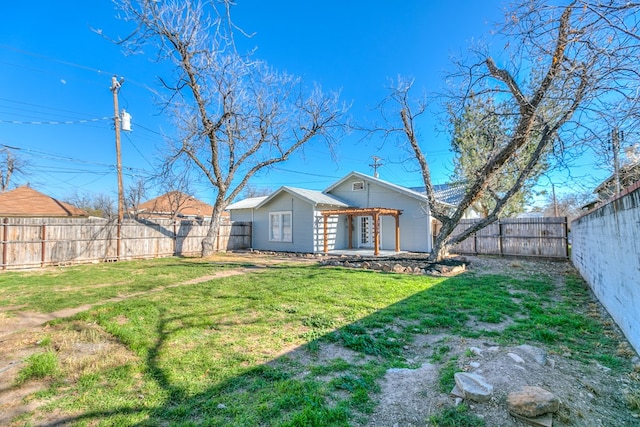 rear view of house featuring a yard