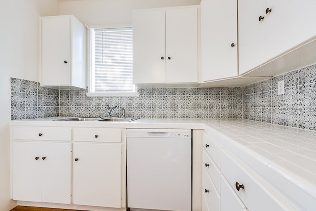 kitchen featuring sink, white cabinetry, tile countertops, dishwasher, and decorative backsplash