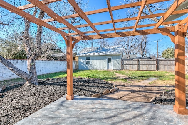 view of patio with an outbuilding and a pergola