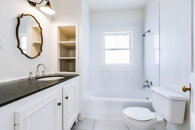 full bathroom featuring tiled shower / bath, vanity, and toilet