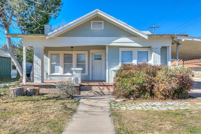 bungalow with a front lawn and a porch