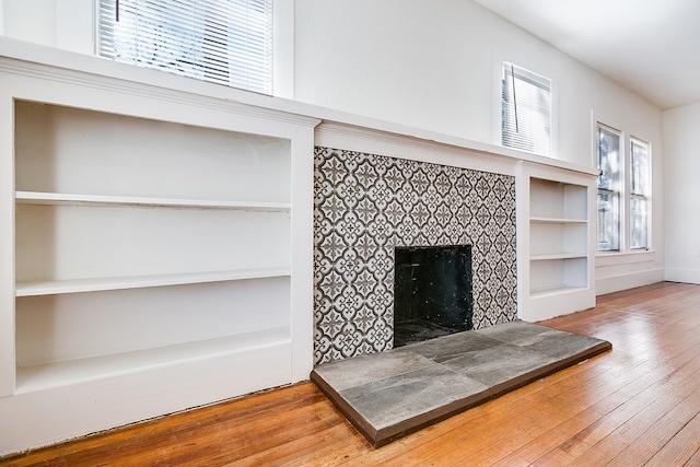 living room with hardwood / wood-style flooring and a tile fireplace