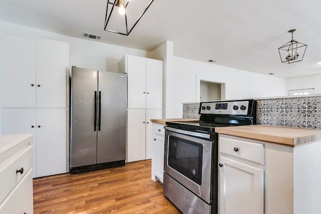 kitchen with pendant lighting, wood counters, white cabinetry, light hardwood / wood-style floors, and stainless steel appliances